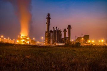 Natural Gas Combined Cycle Power Plant with sunset and light orange
