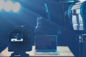 Composer workplace. Headphones, keyboard and a laptop. Computer music concept.With laptop computer, mobile phones.Vloggers , Interview, podcast, video recording in studio, blue background