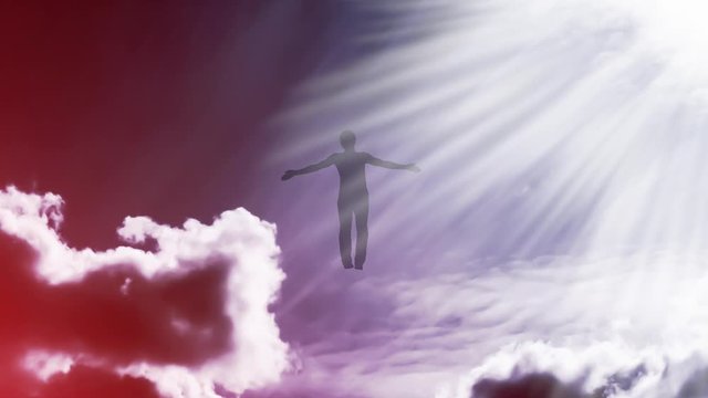 Creative 4k video with the parallax effect of the sky with moving clouds and sunlight, the silhouette of a man with spread arms, flying in bright light and dissolving in it. The concept of open mind.
