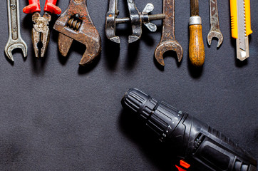 Tools for repair and reconstruction in home conditions lie on a black background