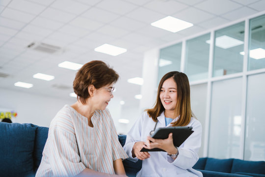 Young doctor consulting senior patient at health care clinic 