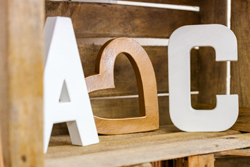 ABC letter with a heart in the middle in a wooden crate