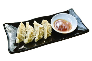 steamed Gyoza or Japanese dumpling stuffed minced pork dipping shoyu sauce on plate