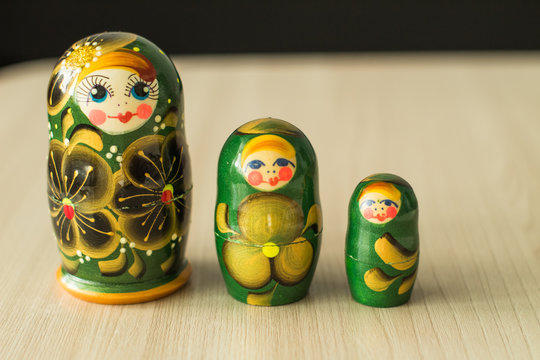 Three Nesting Dolls On The Table