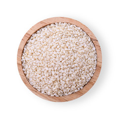 White sesame seeds in a wooden cup isolated on a white background. Top view