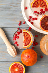 Lemonade, red orange and cranberry on wooden background, top view