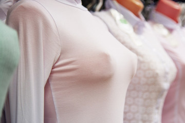 bust of a female mannequin in a white sweater in a store