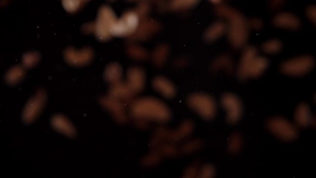 Nut mix fly up and down on a black background. Cooking healthy food with nut mix