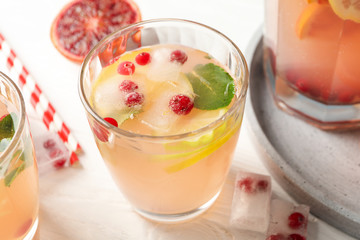 Lemonade with cranberry and lemon on wooden background. Fresh drink