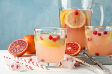 Lemonade with cranberry and lemon on wooden background. Fresh drink