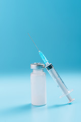 syringe and ampoule on a blue background