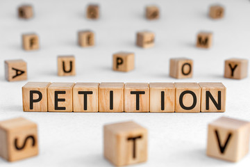 Petition - word from wooden blocks with letters, a formal request petition concept, random letters...