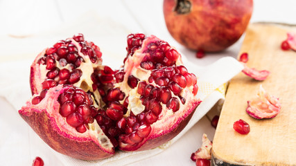 ripe red pomegranate on a white wooden table