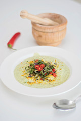 Anti-inflammatory vegan food. Cauliflower and broccoli soup with fresh red chili slices, turmeric and thyme