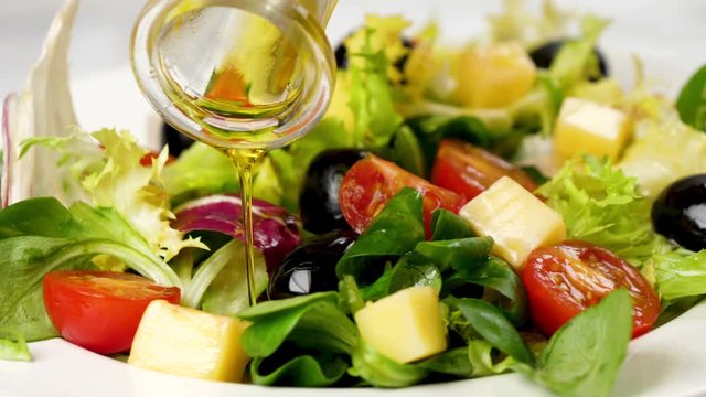vegetable salad with olive oil pouring