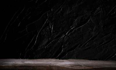 Empty wooden table in front of abstract dark wall background. Can be used to display or edit your products.