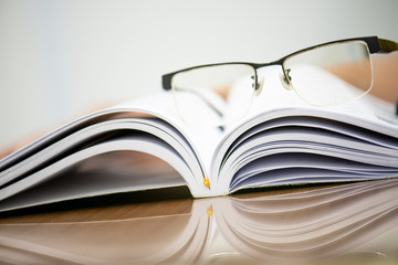 Take a break from reading and take off your glasses and place it on the book,select focus.