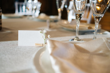 white cards for inscriptions on a white festive table against