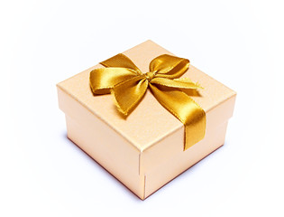 Gift box with a gold bow isolated on a white background. Close up.