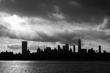 Black and White Lower Manhattan Skyline on the East River in New York City during Sunset with Skyscraper Silhouettes