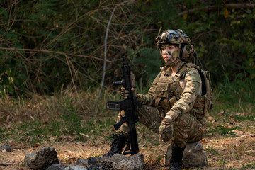 soldier in camouflage aiming with rifle