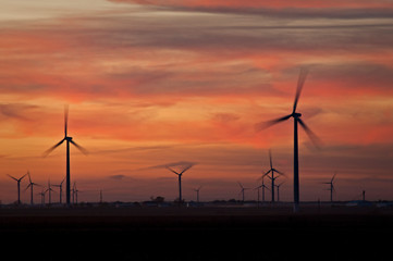Sunset on a wind farm generating clean energy.