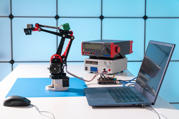 Model of a robot and a laptop on a table in a design office