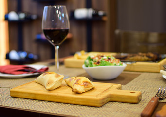 Argentine empanadas with a glass of wine and salads