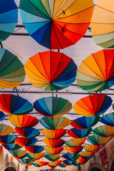 Colourful umbrellas hanging in the street