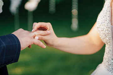 the groom and bride put on each other rings. 