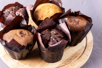 Tasty Chocolate Muffins Decorated with Berries on Old Wooden Tray Gray Background Dessert for Tea or Coffee Horizontal