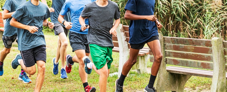Group of boys runing together in a park