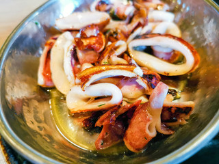 Fresh Grilled octopus served in vintage metallic pan for a mediterranean meal