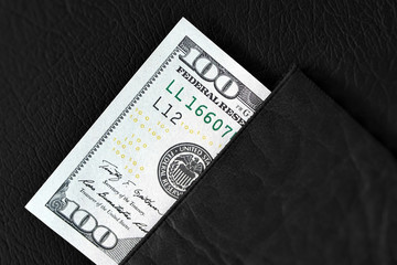 one hundred dollar bills in black wallet luxury