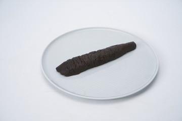 After the fresh sea cucumber is cut with a knife, it is under the white background