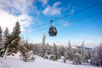Cable car. Beautiful winter landscape with snow covered trees and cable car travel. Krkonose, Pec...