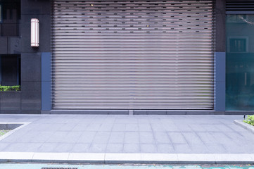 A closeup shot of automatic metal roller door used in factory, storage, garage, and industrial...
