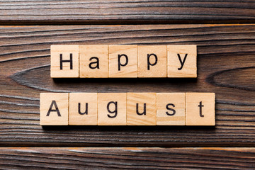 Happy august word written on wood block. Happy august text on table, concept
