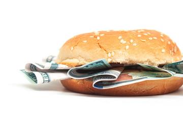 burger with hundred dollar bills instead of toppings on a white background isolate, close up side...