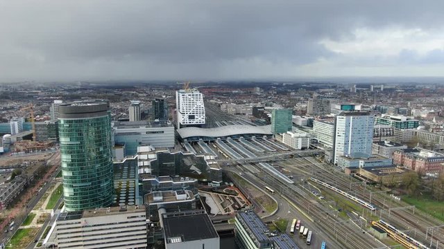 Aerial 4k video of the Utrecht central train station with office buildings and transit oriented development