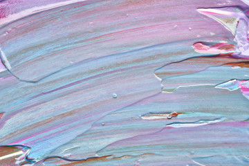 Texture and strokes of multicolored acrylic paint with sparkles on a white background