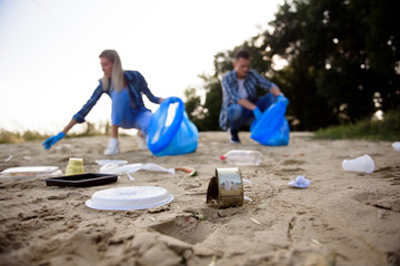 Diverse Group of People Picking Up Trash in The Park Volunteer Community Service.