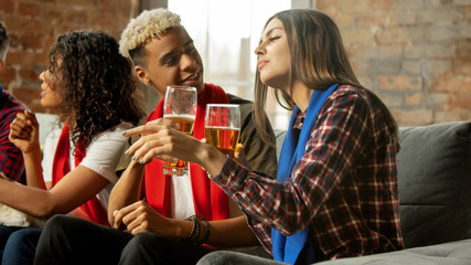 Together. Excited people watching sport match, chsmpionship at home. Multiethnic group of friend, fans cheering for favourite national basketball, tennis, soccer, hockey team. Concept of emotions.