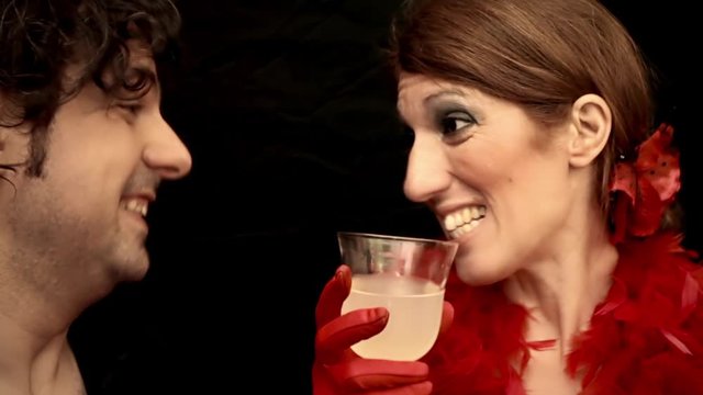 Timelapse: a funny couple at a party, a talkative self-confident woman and a shy bored annoyed man. Comedic shot.