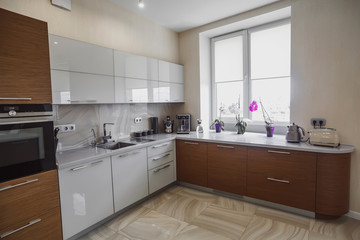 Fototapeta na wymiar View of luxury modern fitted kitchen with stainless steel appliances