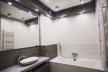 Modern bathroom in white and gray tones with mosaic on wide angle view