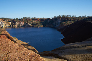 Contaminated pond lake of an old abandoned mine red landscape in Mina de Sao Domingos, Portugal