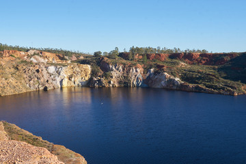 Contaminated pond lake of an old abandoned mine red landscape in Mina de Sao Domingos, Portugal