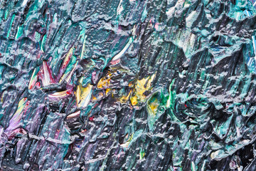Texture and strokes of multicolored acrylic paint with sparkles on a white background