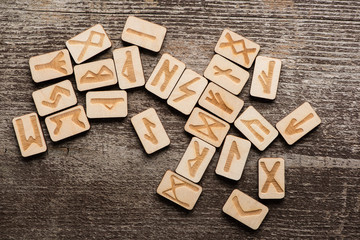 Top view of signs on runes on wooden background